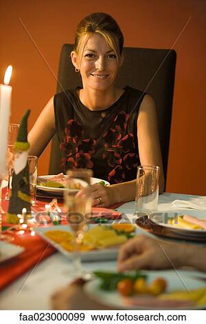 Woman eating candle lit dinner, smiling at camera View Large Photo Image Stock Photo - Woman eating candle lit dinner, smiling at camera. Fotosearch