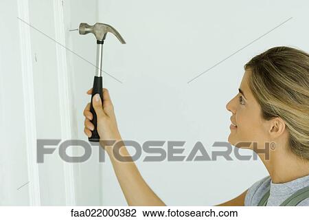 Woman hammering nail, close-up View Large Photo Image Stock Image - Woman hammering nail, close-up. Fotosearch