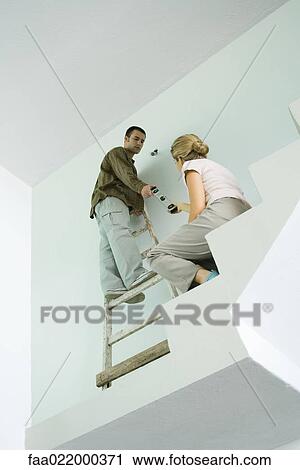 Woman handing man level, low angle view View Large Photo Image Stock Image - Woman handing man level, low angle view. Fotosearch