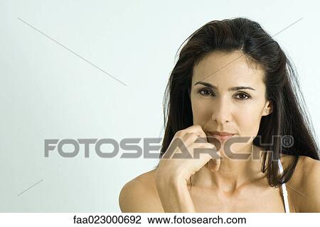 Woman holding hand near mouth, looking at camera, portrait View Large Photo Image Stock Image - Woman holding hand near mouth, looking at camera, portrait. Fotosearch