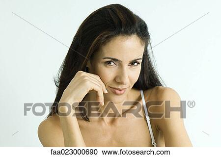 Woman holding hand near mouth, smiling at camera, portrait View Large Photo Image Stock Image - Woman holding hand near mouth, smiling at camera, portrait. Fotosearch