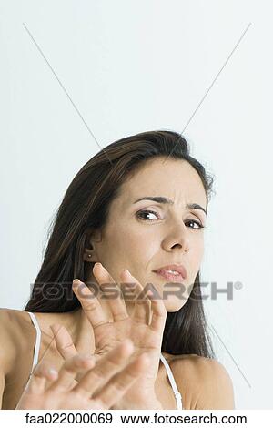 Woman holding out hands, backing away from camera, portrait View Large Photo Image Stock Photo - Woman holding out hands, backing away from camera, portrait. Fotosearch
