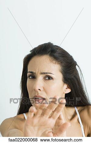 Woman holding out hands, frowning at camera, portrait View Large Photo Image Stock Photo - Woman holding out hands, frowning at camera, portrait. Fotosearch