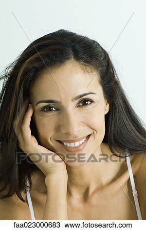 Woman leaning on hand, smiling at camera, portrait View Large Photo Image Stock Image - Woman leaning on hand, smiling at camera, portrait. Fotosearch