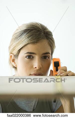 Woman measuring board, focus on woman in background View Large Photo Image Stock Photograph - Woman measuring board, focus on woman in background. Fotosearch