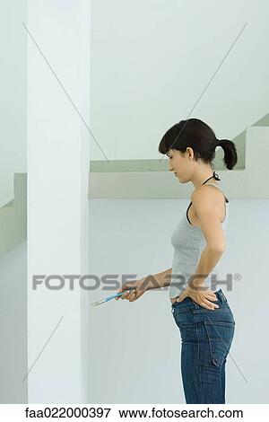 Woman painting post View Large Photo Image Stock Photo - Woman painting post. Fotosearch