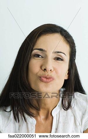 Woman puckering lips, looking at camera, portrait View Large Photo Image Stock Image - Woman puckering lips, looking at camera, portrait. Fotosearch