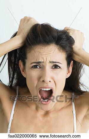 Woman pulling hair and screaming at camera, portrait View Large Photo Image Stock Photography - Woman pulling hair and screaming at camera, portrait. Fotosearch