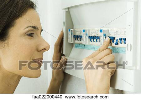 Woman pushing lever in fuse box View Large Photo Image Stock Image - Woman pushing lever in fuse box. Fotosearch