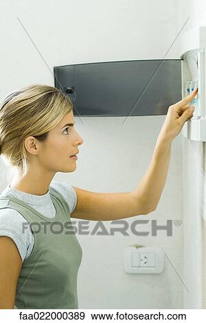 Woman pushing lever in fuse box View Large Photo Image Stock Photo - Woman pushing lever in fuse box. Fotosearch