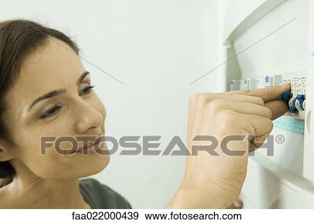 Woman pushing lever in fuse box View Large Photo Image Stock Photo - Woman pushing lever in fuse box. Fotosearch