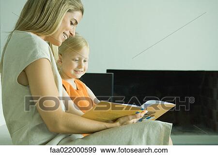 Woman reading book with little girl View Large Photo Image Stock Photo - Woman reading book with little girl. Fotosearch