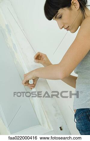 Woman removing masking tape from freshly painted woodwork on door View Large Photo Image Stock Photograph - Woman removing masking tape from freshly painted woodwork on door. Fotosearch