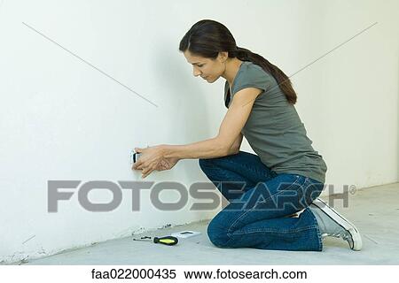 Woman replacing outlet cover View Large Photo Image Stock Photography - Woman replacing outlet cover. Fotosearch