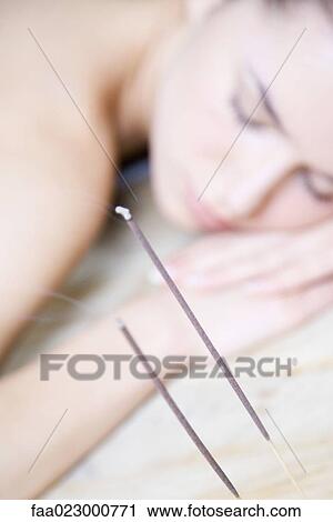 Woman resting head on arms, eyes closed, incense burning in foreground View Large Photo Image Stock Image - Woman resting head on arms, eyes closed, incense burning in foreground. Fotosearch