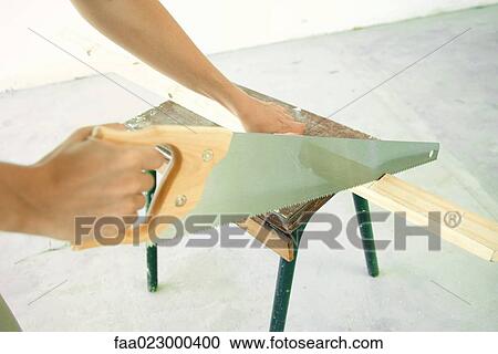 Woman sawing piece of wood, close-up of hands View Large Photo Image Stock Image - Woman sawing piece of wood, close-up of hands. Fotosearch