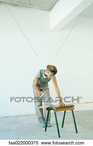 Woman sawing wood plank View Large Photo Image Stock Photography - Woman sawing wood plank. Fotosearch