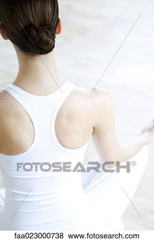 Woman sitting in lotus position, rear view View Large Photo Image Stock Photo - Woman sitting in lotus position, rear view. Fotosearch