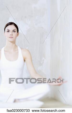 Woman sitting in lotus position, looking up View Large Photo Image Stock Image - Woman sitting in lotus position, looking up. Fotosearch