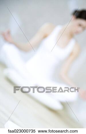 Woman sitting in lotus position, defocused, tilted view View Large Photo Image Stock Photography - Woman sitting in lotus position, defocused, tilted view. Fotosearch
