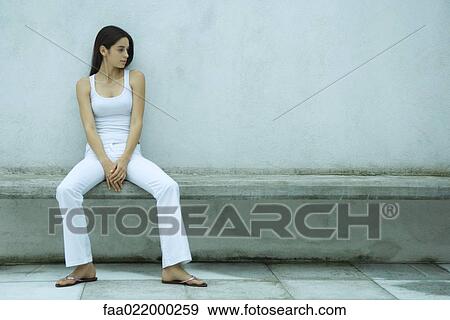Woman sitting on bench, looking at empty place next to her View Large Photo Image Stock Photo - Woman sitting on bench, looking at empty place next to her. Fotosearch