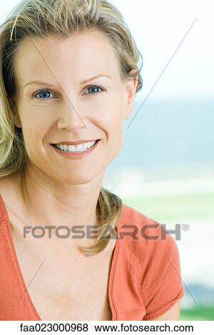 Woman smiling at camera, portrait View Large Photo Image Stock Photo - Woman smiling at camera, portrait. Fotosearch