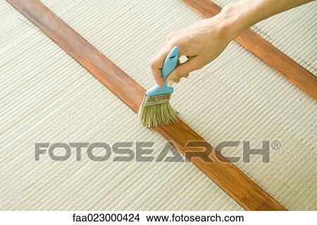 Woman staining piece of wood, close-up of hand View Large Photo Image Picture - Woman staining piece of wood, close-up of hand. Fotosearch