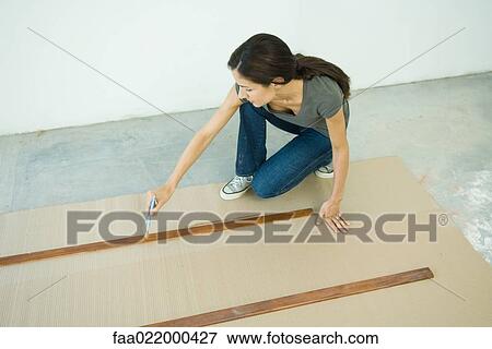 Woman staining slats of wood View Large Photo Image Stock Photo - Woman staining slats of wood. Fotosearch