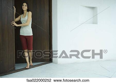 Woman standing in doorway, full length portrait View Large Photo Image Stock Image - Woman standing in doorway, full length portrait. Fotosearch
