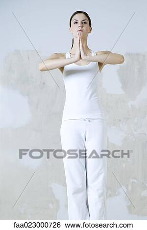 Woman standing in prayer position, looking away View Large Photo Image Stock Photograph - Woman standing in prayer position, looking away. Fotosearch