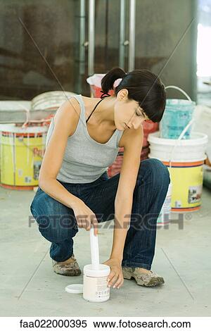 Woman stirring paint product View Large Photo Image Stock Photography - Woman stirring paint product. Fotosearch