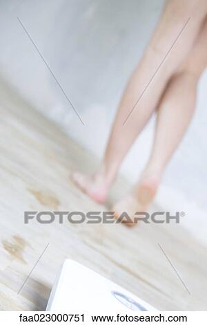 Woman walking away from bathroom scale, low section, cropped view View Large Photo Image Stock Image - Woman walking away from bathroom scale, low section, cropped view. Fotosearch