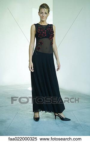 Woman wearing evening gown, full length portrait View Large Photo Image Stock Photography - Woman wearing evening gown, full length portrait. Fotosearch