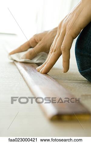 Woman wiping stained piece of wood, close-up of hands View Large Photo Image Stock Image - Woman wiping stained piece of wood, close-up of hands. Fotosearch