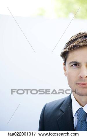 Young businessman looking at camera, portrait, cropped view View Large Photo Image Stock Photo - Young businessman looking at camera, portrait, cropped view. Fotosearch
