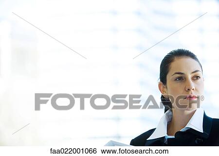 Stock Photograph - Young businesswoman looking away, head and shoulders, portrait. Fotosearch