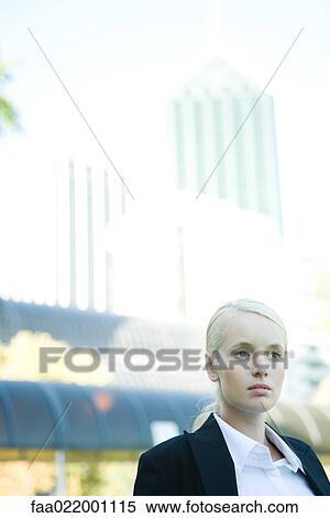 Stock Photography - Young businesswoman outdoors, head and shoulders, portrait. Fotosearch