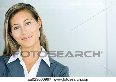 Young businesswoman smiling at camera, head tilted, portrait View Large Photo Image Stock Photo - Young businesswoman smiling at camera, head tilted, portrait. Fotosearch