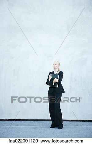 Young businesswoman standing, arms folded, full length View Large Photo Image Stock Image - Young businesswoman standing, arms folded, full length. Fotosearch
