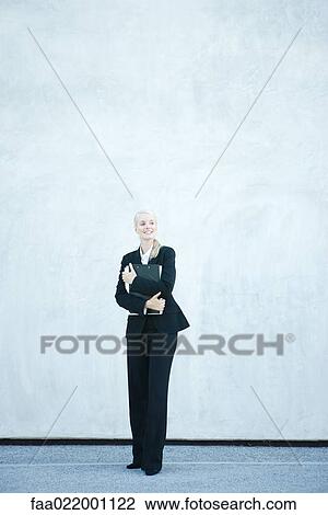 Young businesswoman standing, arms folded, smiling, full length View Large Photo Image Stock Image - Young businesswoman standing, arms folded, smiling, full length. Fotosearch