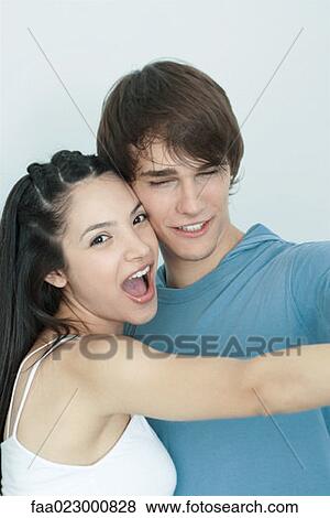 Stock Photo - Young couple, dancing cheek to cheek, portrait. Fotosearch