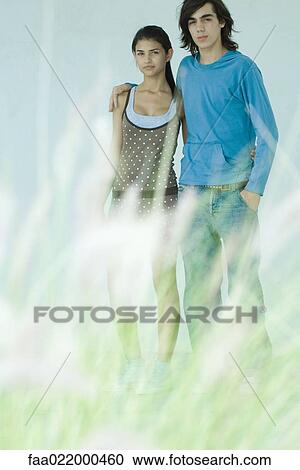 Young couple, focus on background, full length View Large Photo Image Stock Image - Young couple, focus on background, full length. Fotosearch