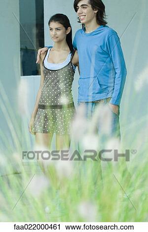 Stock Image - Young couple, focus on background. Fotosearch