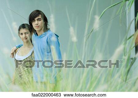 Stock Image - Young couple, focus on background. Fotosearch