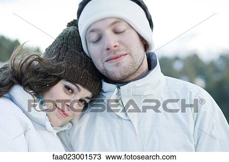 Young couple in ski clothes, young woman resting head on boyfriend's shoulder View Large Photo Image Stock Image - Young couple in ski clothes, young woman resting head on boyfriend's shoulder. Fotosearch
