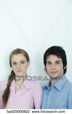 Young couple looking at camera, head and shoulders, portrait View Large Photo Image Stock Image - Young couple looking at camera, head and shoulders, portrait. Fotosearch