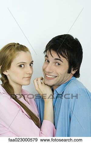 Young couple looking at camera together, man smiling, portrait View Large Photo Image Stock Photo - Young couple looking at camera together, man smiling, portrait. Fotosearch