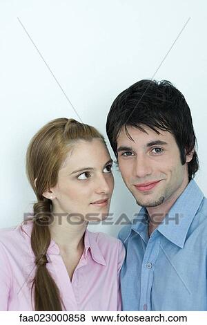 Young couple, man smiling at camera, woman looking at man with admiration, portrait View Large Photo Image Stock Photo - Young couple, man smiling at camera, woman looking at man with admiration, portrait. Fotosearch