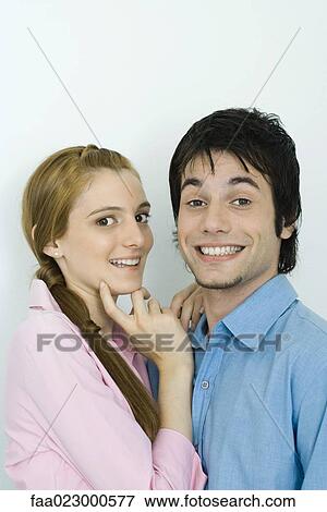 Young couple smiling at camera together, portrait View Large Photo Image Stock Photo - Young couple smiling at camera together, portrait. Fotosearch
