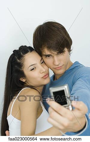 Young couple taking self portrait with digital camera View Large Photo Image Picture - Young couple taking self portrait with digital camera. Fotosearch
